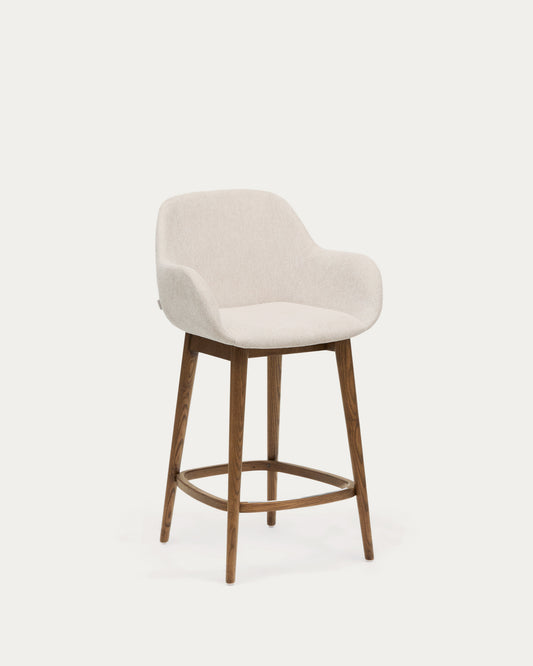 Tabouret Konna beige et pieds en bois de frêne finition foncée 65 cm